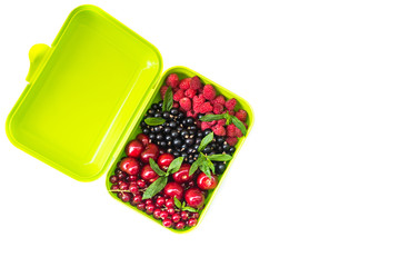 Berry mix: cherry, red and black currant, raspberry in a light green container.