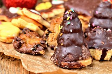Close-up of christmas sweets with different types of candy on baking paper and Christmas decorations