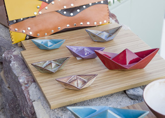 Colorful ceramic  figures of boats, souvenirs from Santorini