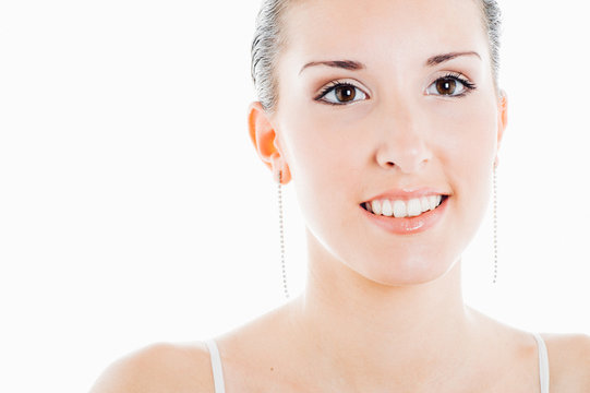 Young caucasian smiling brunette poses for a beauty session in studio with white background