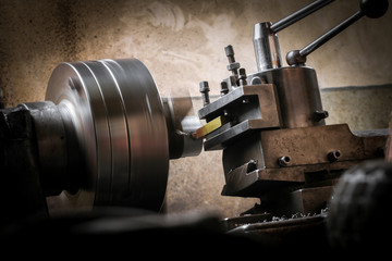 Metal worker working on lathe