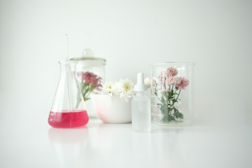 cosmetic skincare beauty product .natural organic flower oil ingredient in the laboratory. packaging spa concept.