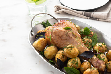 Roast turkey drumsticks with fried potatoes, basil. Holiday dinner. Copy space.