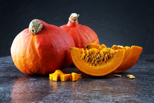 Pumpkin slices with seeds and autumn hokkaido pumpkins