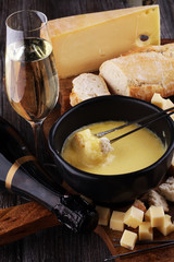 Gourmet Swiss fondue dinner on a winter evening with assorted ch