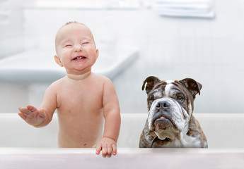 baby and dog in the tub