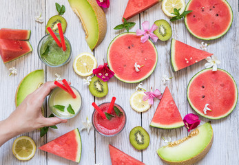 Somebody taking a smoothie from a table with fruits. Colorful fresh fruits. Flat lay, top view