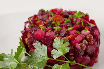 Salad from the beet. Vinaigrette is a traditional Russian salad made from beets and vegetables. . The background is white. Copy space.