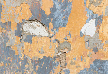 yellow and blue paint peeling off wall background