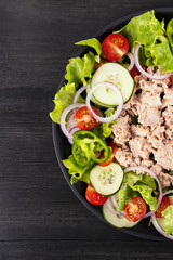 Salad with tuna and vegetables. Mediterranean food. Top view. Copy space.