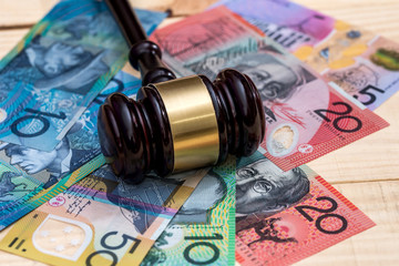 Judge's gavel on australian dollar banknotes closeup