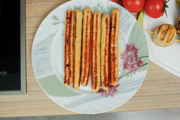 sausage ready on the grill lies on the table