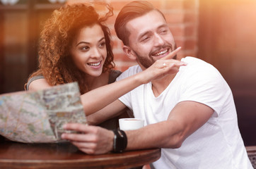 A picture of  tourists looking at map in a cafe