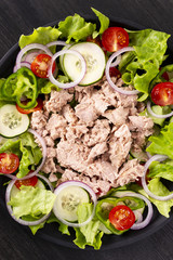 Salad with tuna and vegetables. Mediterranean food. Top view.