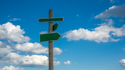 the direction sign with clouds background