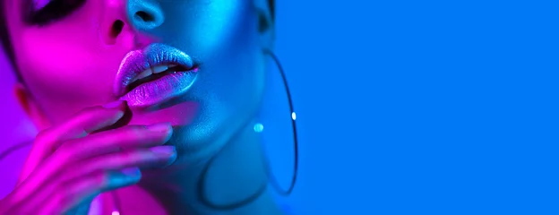 Foto op Canvas High fashion model vrouw in kleurrijke felle neonlichten poseren in studio. Mooi sexy meisje, trendy gloeiende make-up, metallic zilveren lippen © Subbotina Anna