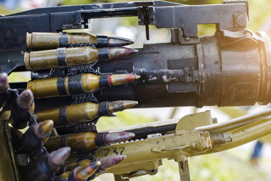 tape with cartridges loaded into a machine gun