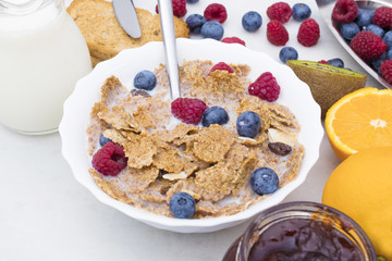 cup of cereals with fruits and milk, balanced and healthy breakfast