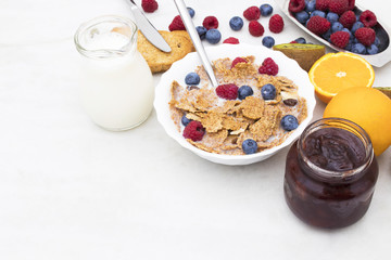 cup of cereals with fruits and milk, balanced and healthy breakfast