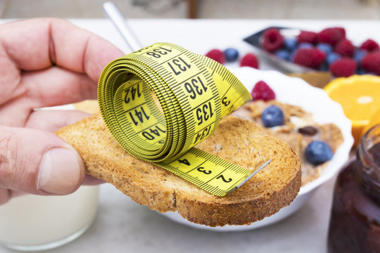 toasted bread with tape measure and healthy breakfast, concept of diet