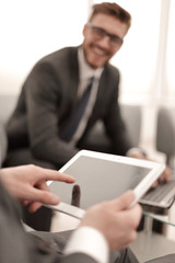 close up.businessman tapping the screen of the digital tablet