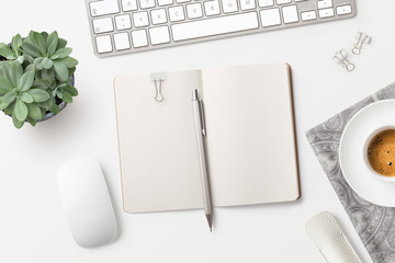 bright minimalist workspace / desktop with blank open notebook, office supplies, coffee and succulent plant on a white background - top view, copyspace - obrazy, fototapety, plakaty