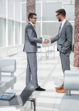 Handshake Two Employees Standing In The Office