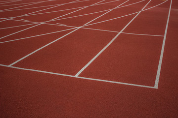 Fototapeta premium empty red running track road background texture concept with white marking lanes nobody and space for copy or text 