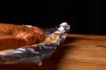 Tart with apricots on wooden table background close up