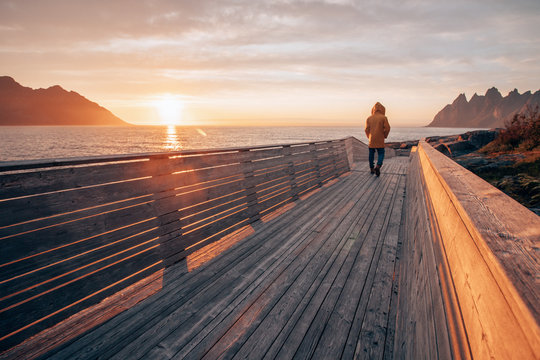 a lonely man standing in the middle of a footpath in Tungeneset, Norway while sunset