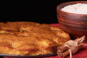 apricot pie and a bowl with flour and other ingredients and tools table