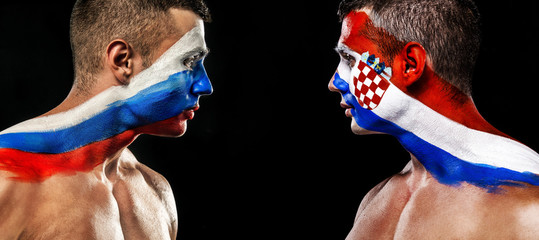 Soccer or football fan with bodyart on face with agression - flags of Russia vs Croatia, playoff. Sport Concept with copyspace.