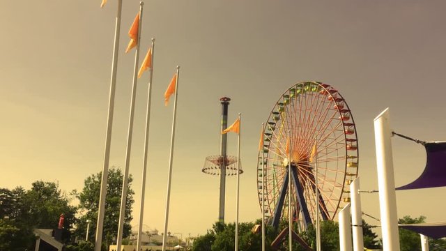 Sunset at an amusement park by ferris wheel