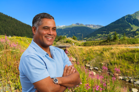 Handsome Hispanic man in the Swiss Alps