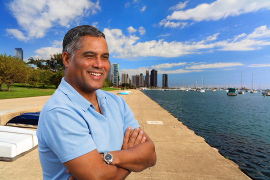 Handsome Hispanic man in a downtown urban waterfront setting