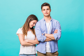 Portrait of a young couple hug standing against mint blue gray background