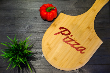 cutting board with the inscription pizza, flat lay