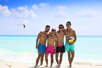 Group of male friends having fun at the beach
