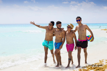 Group of male friends having fun at the beach