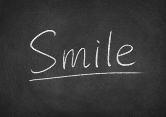 Obraz premium smile concept word on a blackboard background