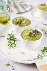Appetizer: green vegetable soufflе with grated Parmesan cheese and olive oil, three servings