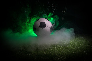 Traditional soccer ball on soccer field. Close up view of soccer ball (football) on green grass...