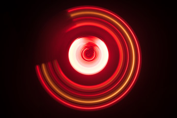 Music concept. Freezelight glowing vinyl on dark background or Turntable playing vinyl with glowing abstract lines concept on dark background.