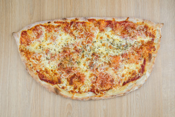 Pizza calzone time on light wooden table background
