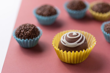 Homemade chocolate truffle surrounded by brigadeiro candy, brazilian dessert.