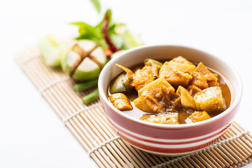 Fish organs sour soup (Kaeng Tai Pla) in a bowl and vegetables, Southern Thai food