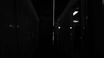 Warehouse Worker Opening and Closing Metal Door. Black and White Tone. Zoom In.