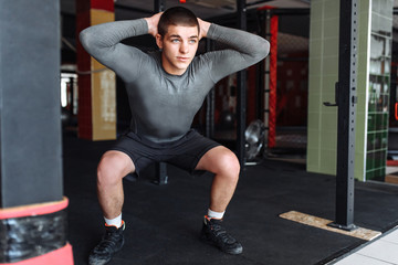 Fototapeta na wymiar Athlete warming up before a workout at the gym, boxer training