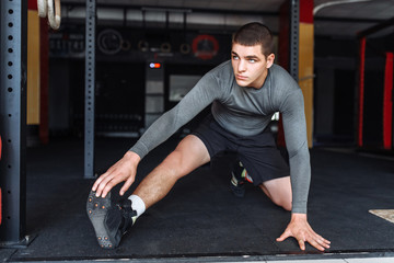 Fototapeta na wymiar Athlete warming up before a workout at the gym, boxer training