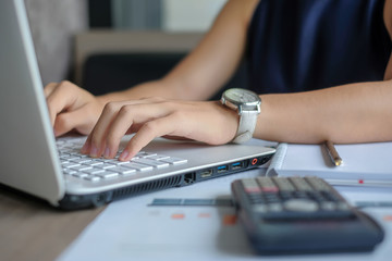 Businesswoman using laptop for analysis maketing plan, Manager calculate financial report and graph chart.  Business, Finance and Accounting concepts